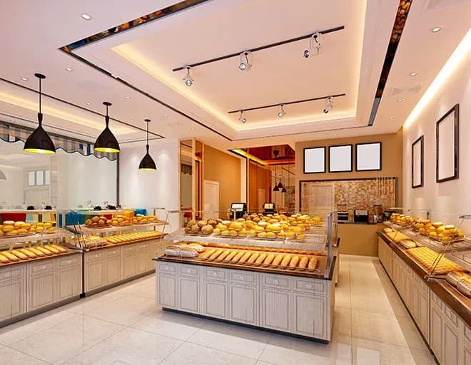 intérieur de boulangerie avec comptoirs vitrines garnis de pains et éclairage chaleureux