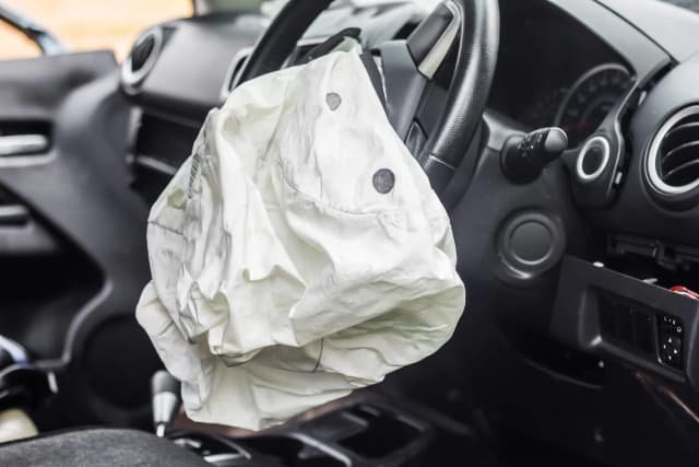 airbag déployé sur le volant d'une voiture dans un intérieur automobile