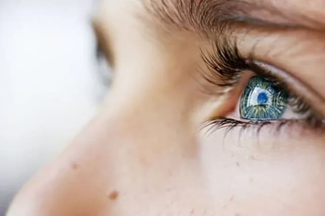 oeil d'enfant avec des cils longs et un iris bleu éclatant
