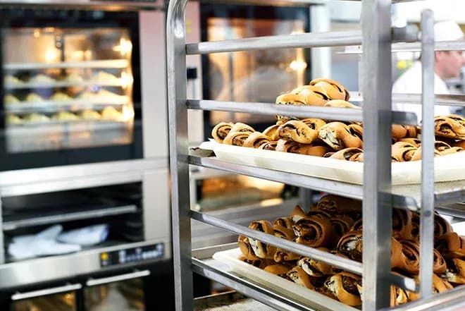 pâtisseries roulées sur chariot en cuisine professionnelle