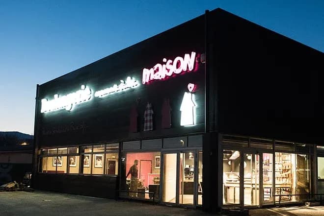 bâtiment d'une boulangerie avec enseigne lumineuse et vitrine au crépuscule