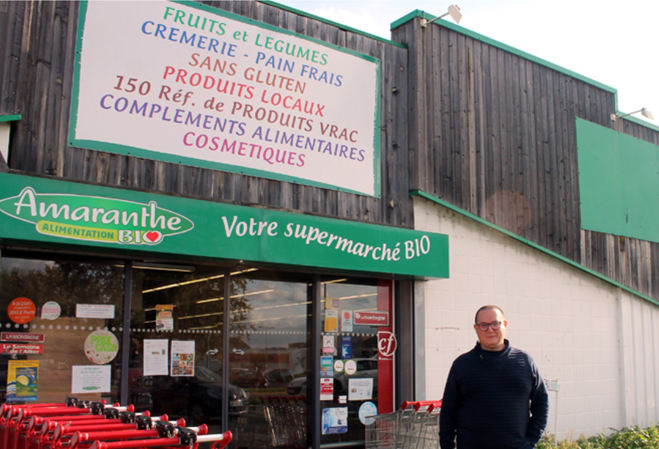 Dimitri Vargues en photo devant la façade du magasin bio Amaranthe