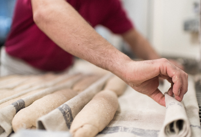 Boulanger qui prépare ses baguettes pour les enfourner.