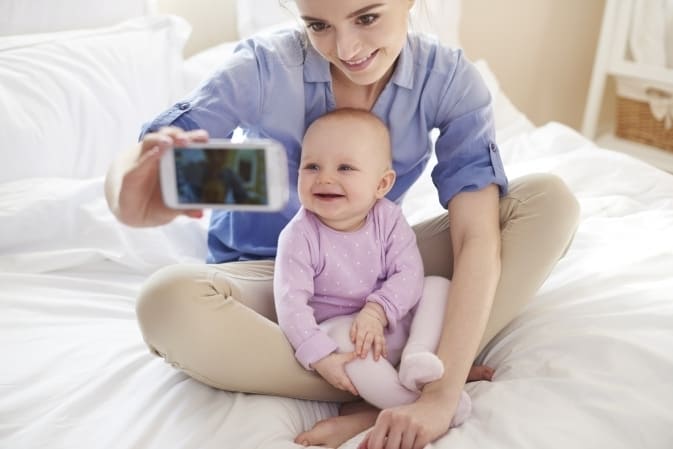 Maman entrain de prendre un selfie avec bébé