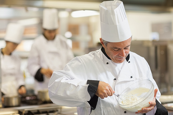 Pâtissier qui prépare une crème pâtissière